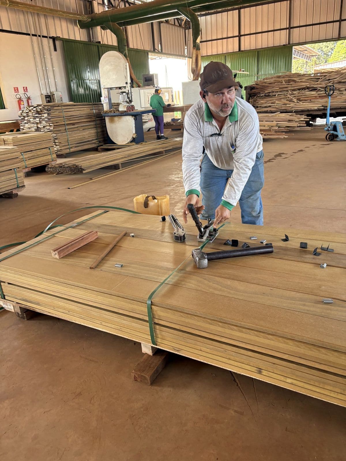 Marine Box inspector grading export hardwood boards at a partner producer's yard